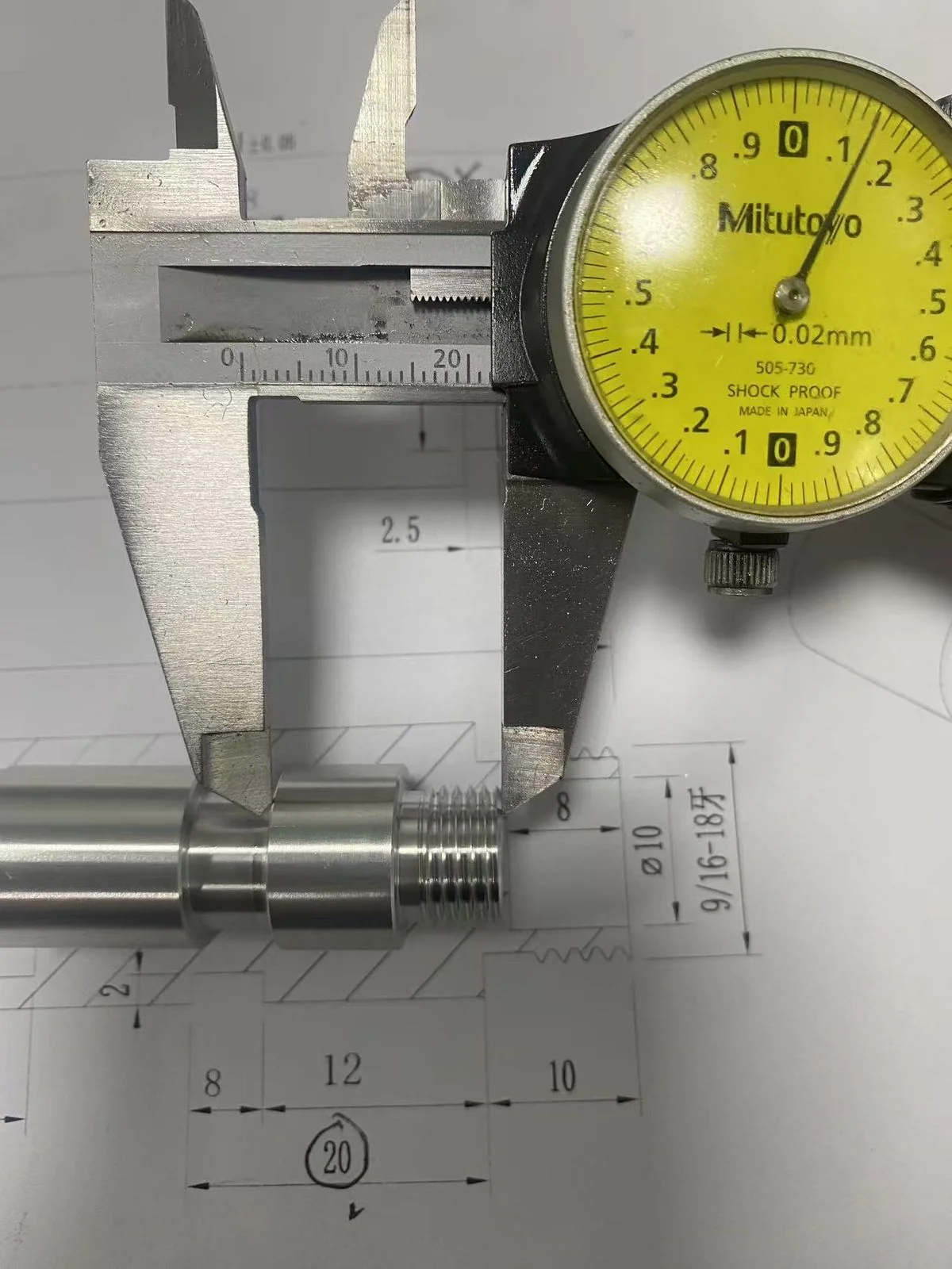 Dial caliper measuring the O-ring groove width on the multi-thread stud against the technical drawing