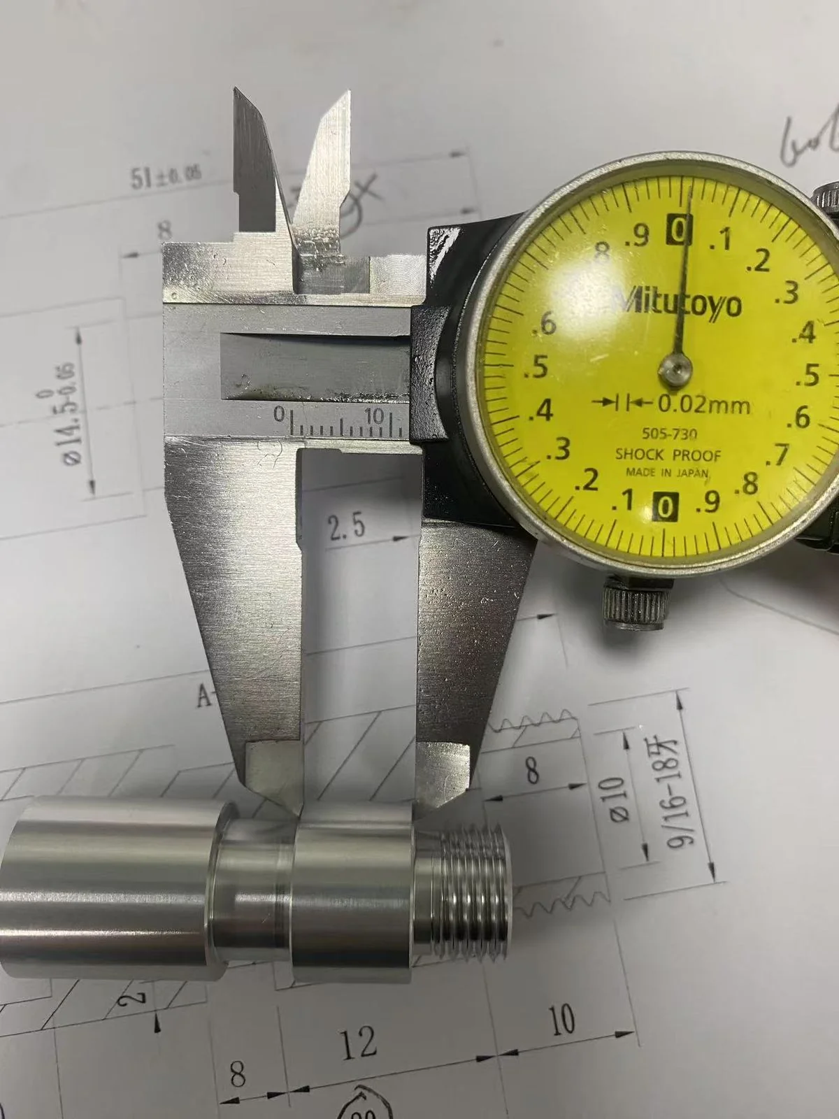 Dial caliper measuring a fit diameter on the multi-thread stud against the technical drawing