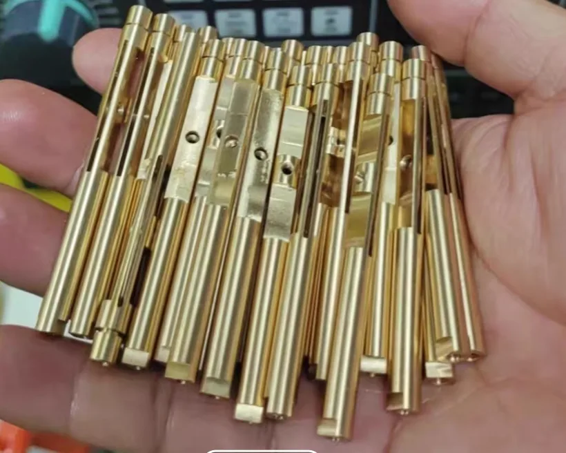 Handful of brass stems with milled flats, slots and cross holes