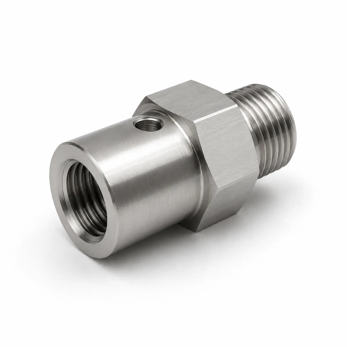 Custom sensor port thread adapter in stainless steel with cross-drilled hole, female to male ends