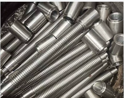 Batch of machined studs with threads on both ends and a plain unthreaded middle section, in bright steel