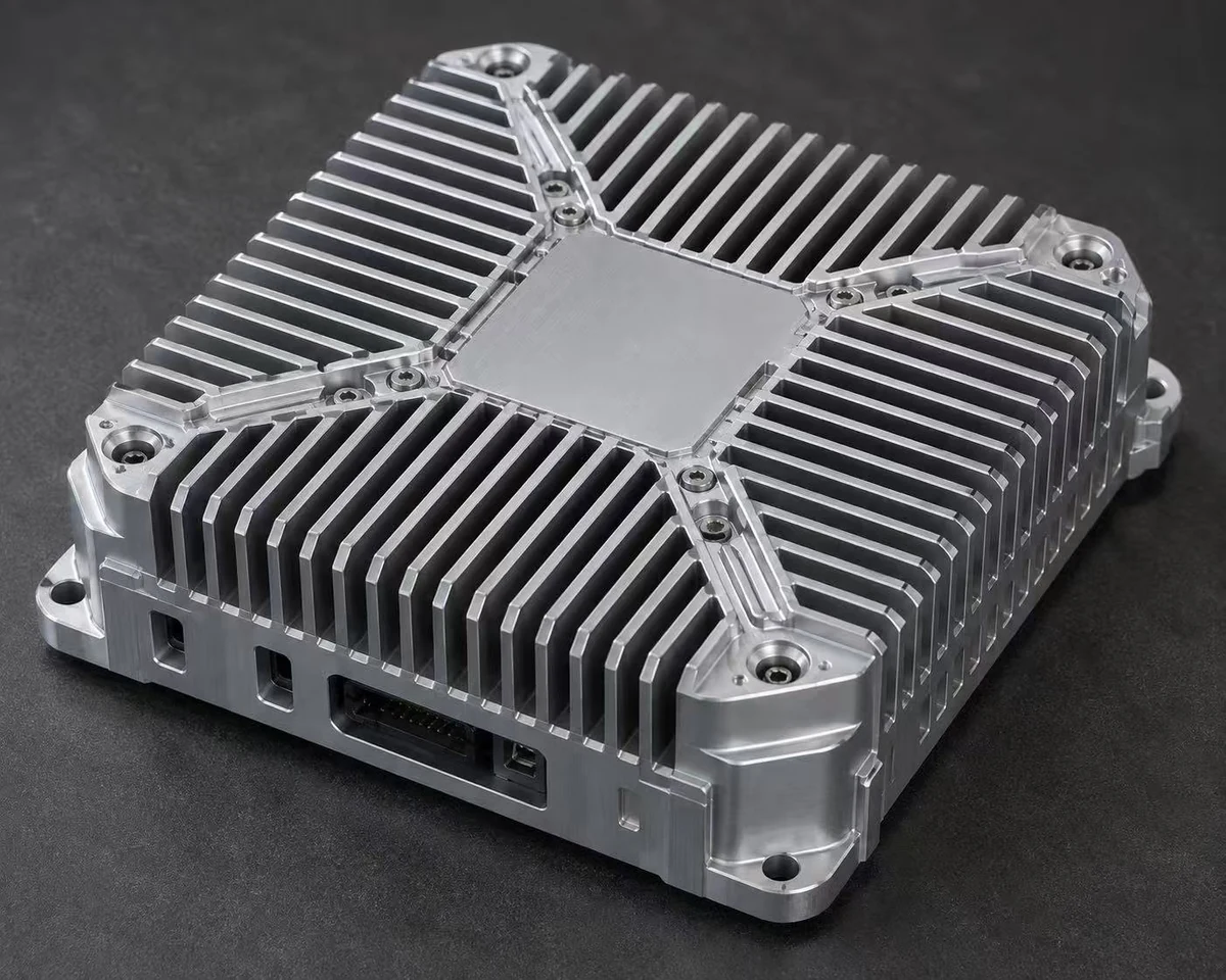 CNC machined aluminum heatsink enclosure — fanless housing with integrated cooling fins, machined connector openings and mounting feet