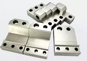 Machined steel clamping jaws in matched pairs with counterbored fixing holes and stepped gripping faces