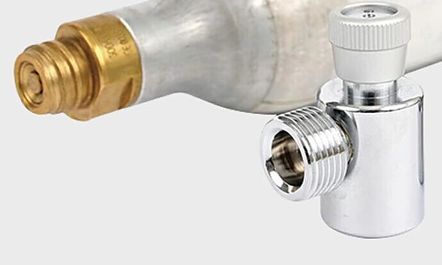 Chrome-plated on/off adapter with a knurled knob on top and a male side outlet, beside the brass TR21-4 valve of a carbonator cylinder