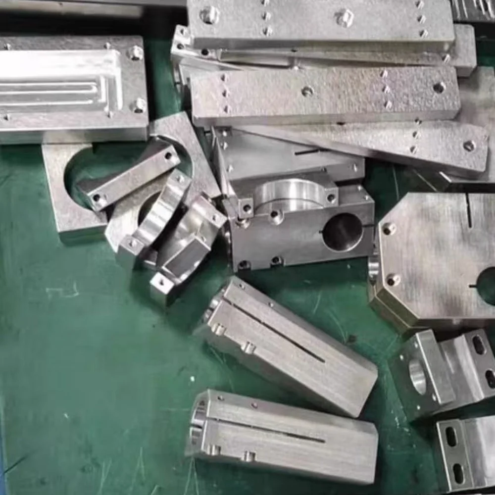 Batch of CNC-machined aluminium parts — bespoke components like these rarely carry a part number and are reproduced directly from the sample