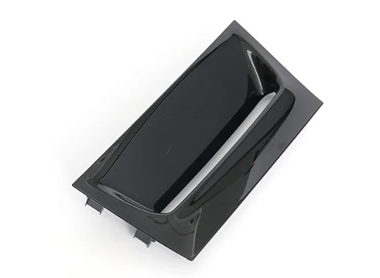 Same injection molded gloss black panel viewed at an angle, showing snap tabs on the underside