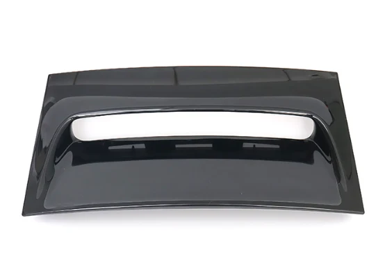 Injection molded gloss black plastic panel with an integrated handle recess, front view
