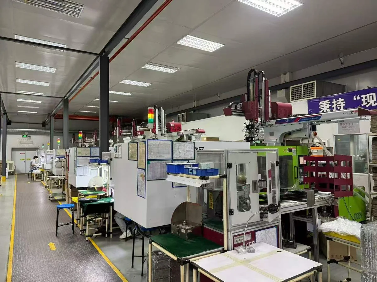 Injection molding line with overhead takeout robots and operator inspection stations at a partner facility