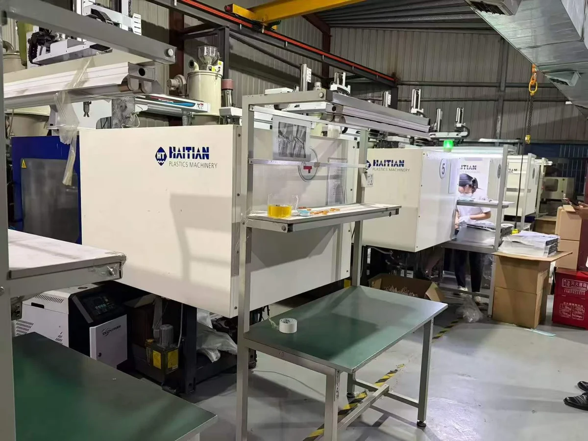 Row of Haitian injection molding machines running production at an EKINSUN partner facility