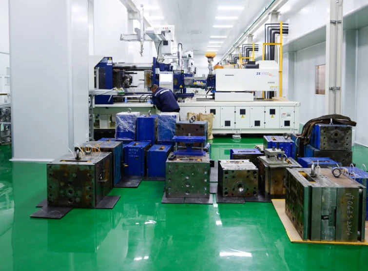 Steel injection mold blocks standing on the floor of a partner molding facility, each one the tooling for a single part