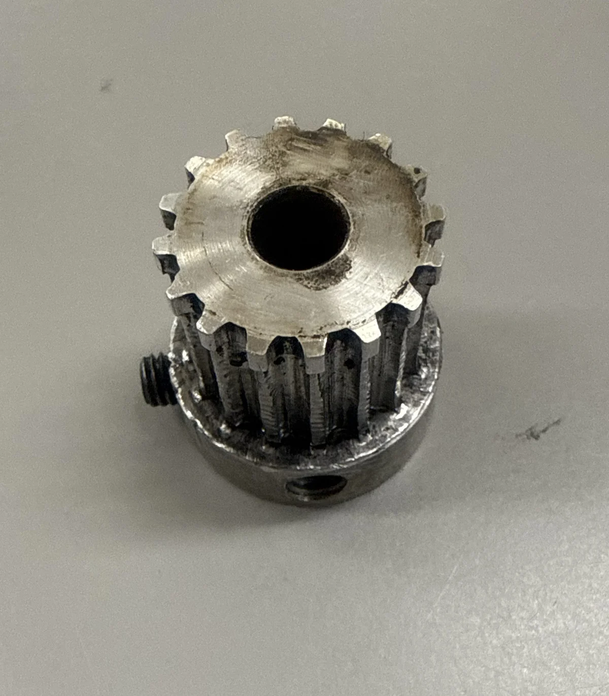 Worn embroidery machine gear with integral hub and set screw, sent in by a customer as the sample to copy