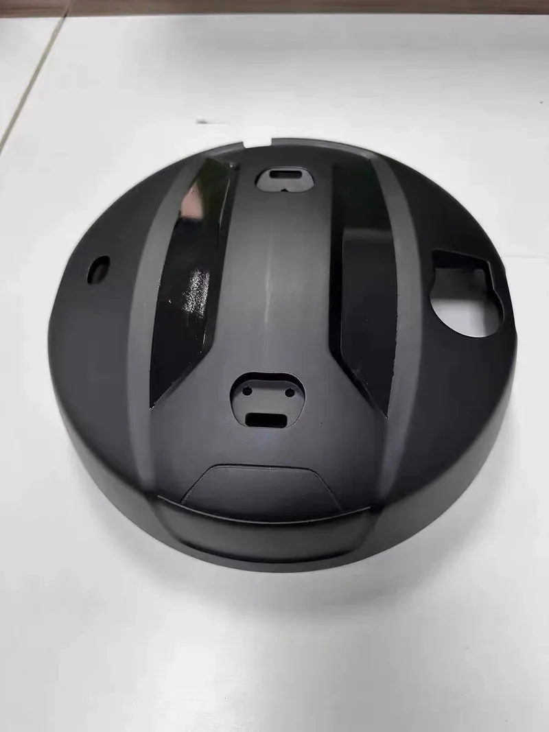 Large round cast plastic cover with matte body panels and gloss inserts in a two-tone finish