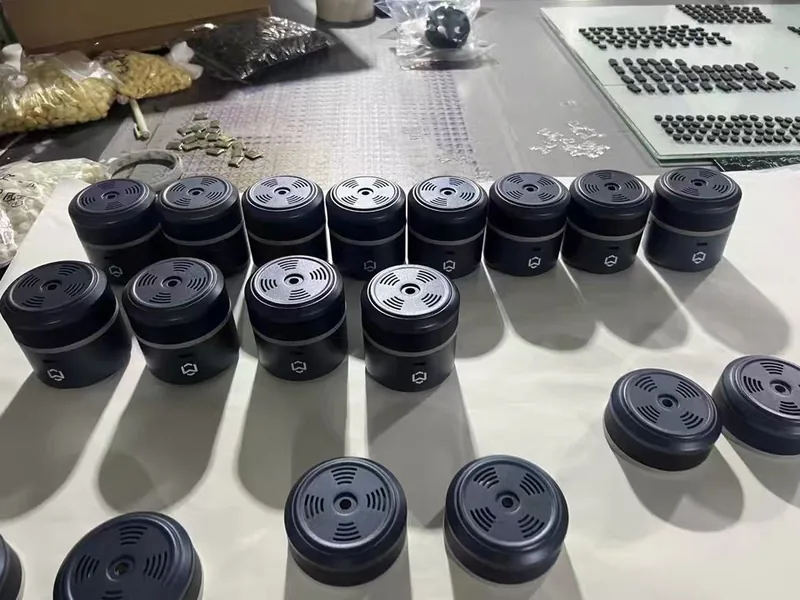 Cast plastic sensor housings assembled with concentric grille faces on an assembly bench